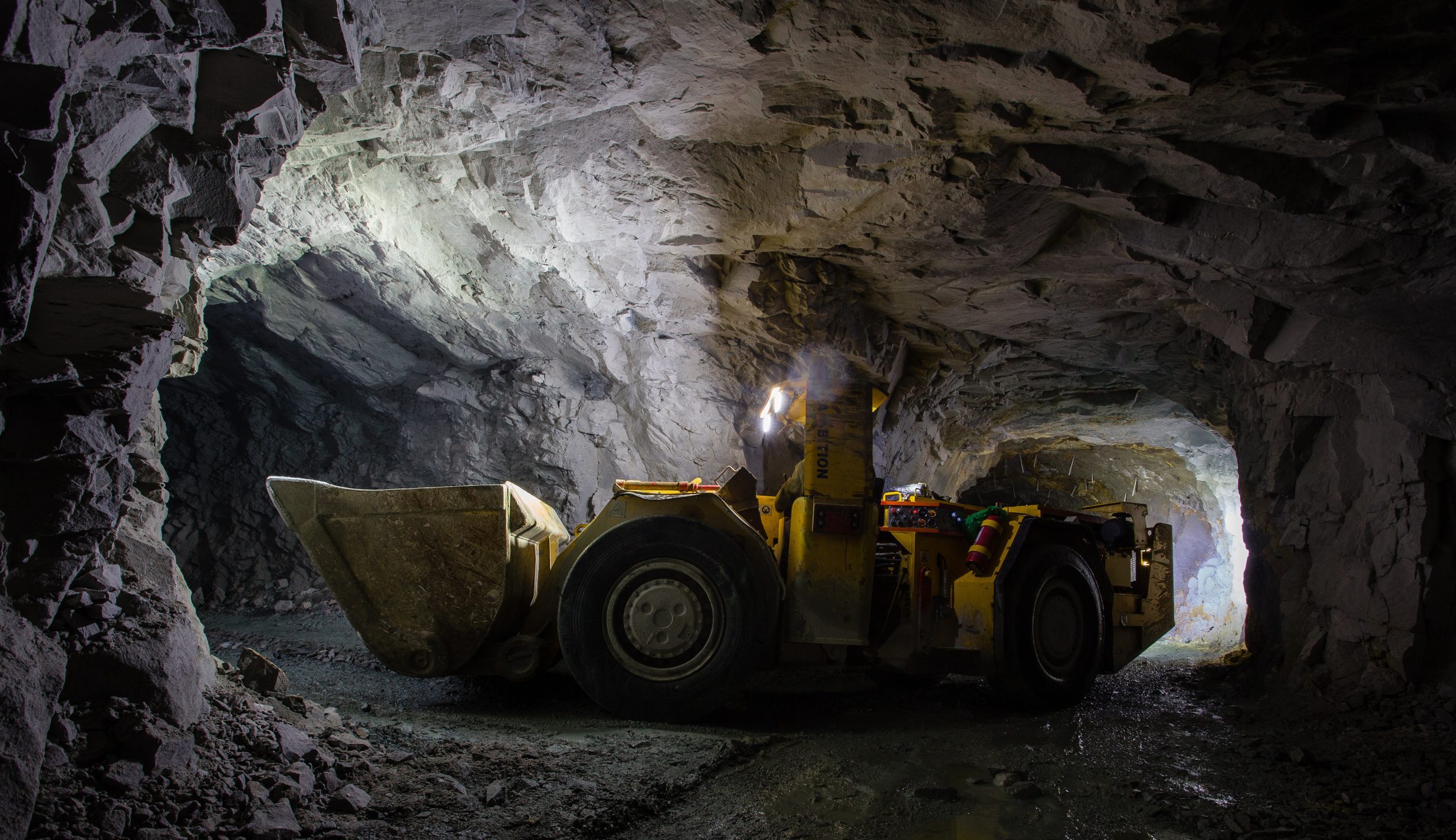 Underground gold ore mine shaft tunnel gallery passage with load, haul, dump machine LHD